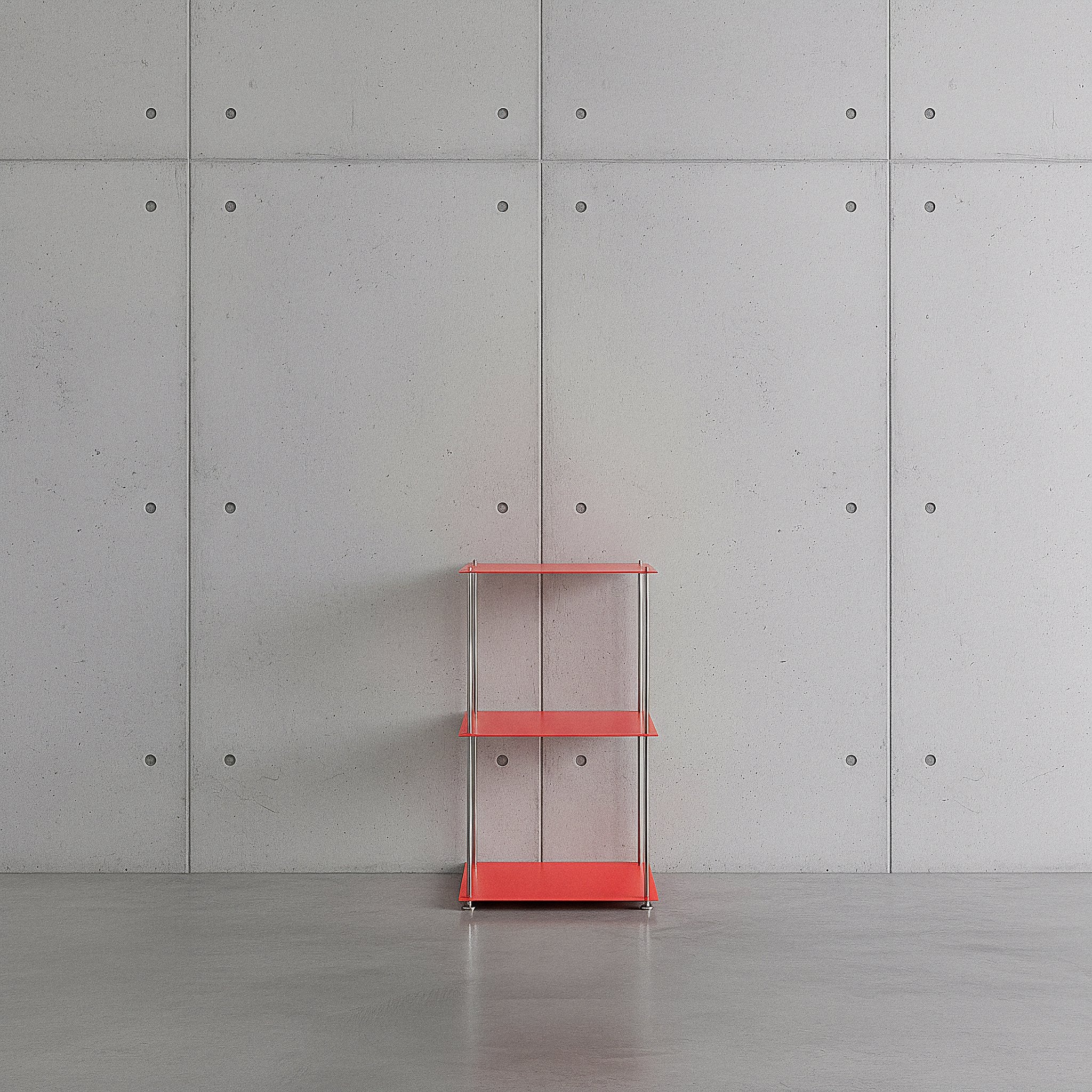 Modulum mit 3 Fachböden in leuchtrot auf grauen Betonboden vor grauer Betonwand mit Löchern