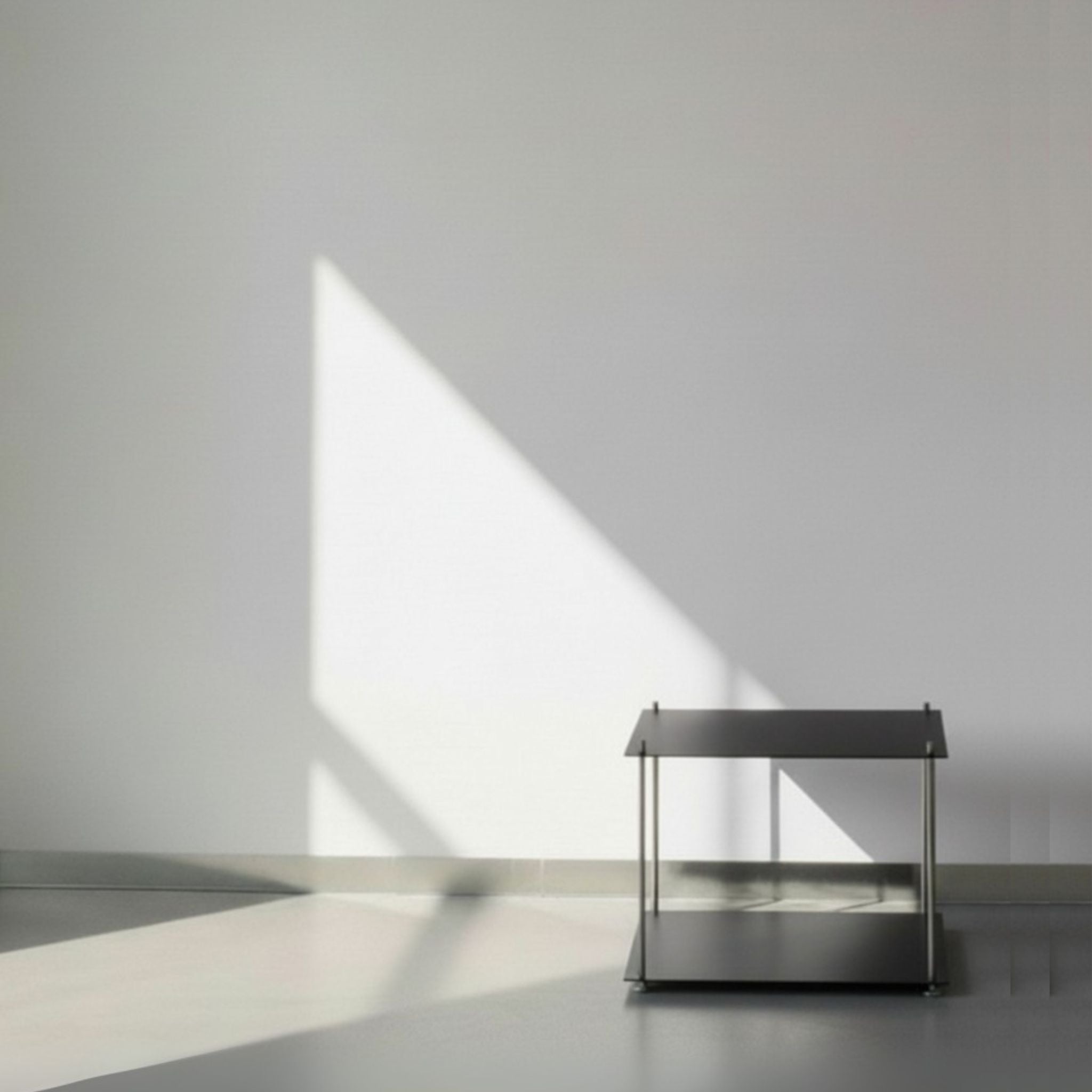 Modulum in schwarz ultramatt mit Basismodul auf grauen Betonboden vor weißer Wand und Lichtspiel