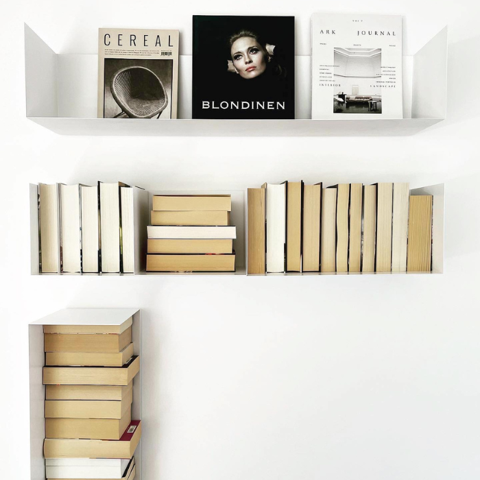 Weiße Wandregale mit Büchern und Magazinen in modernem minimalistischen Design, stilvolle Wanddekoration