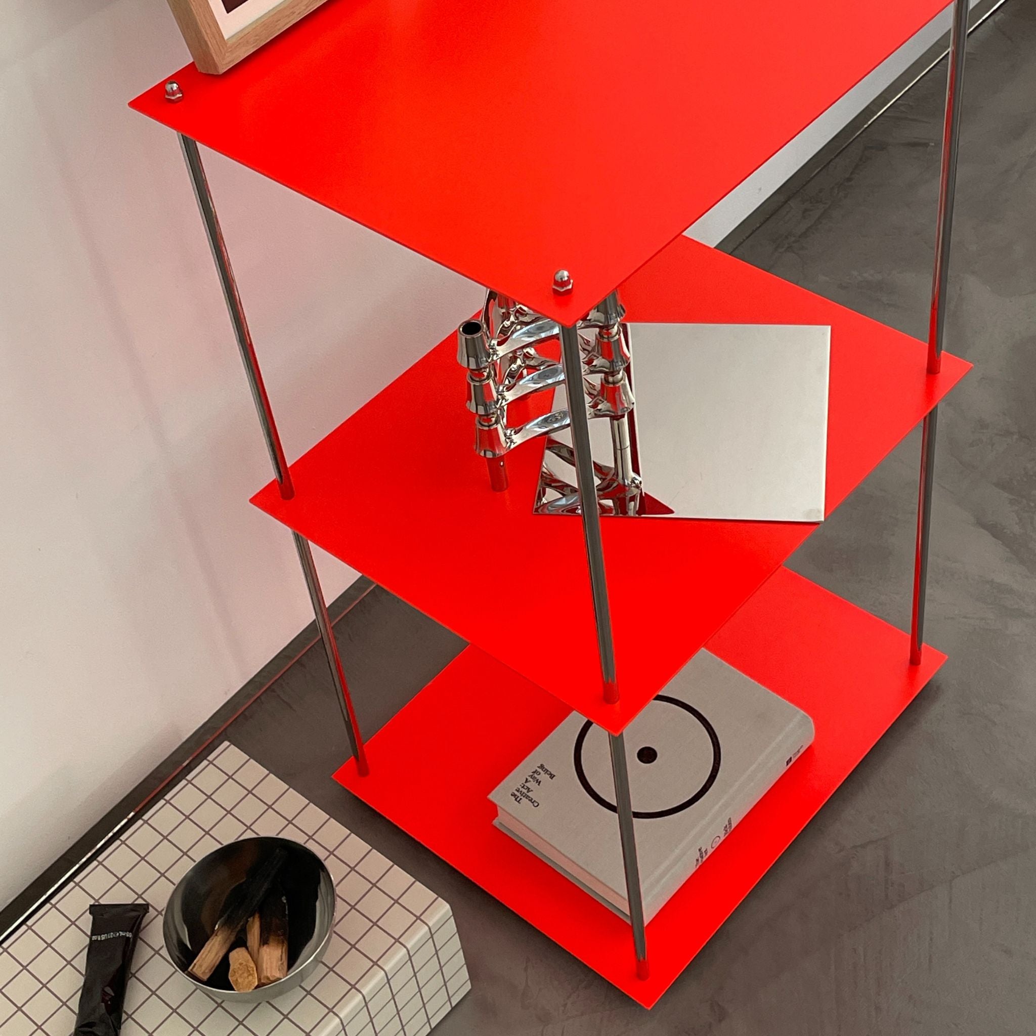 Detailansicht des modularen Regals in Leuchtrot mit Designobjekten, pulverbeschichtet von MO INTERIORS